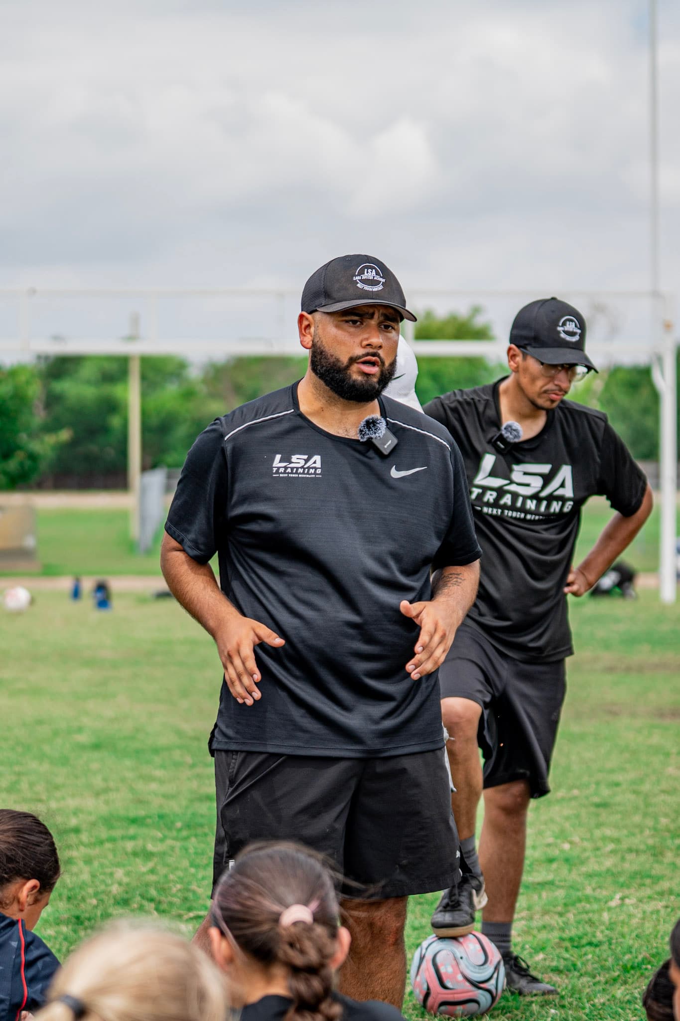 Coach Carlos Lara walking with an assistant coach