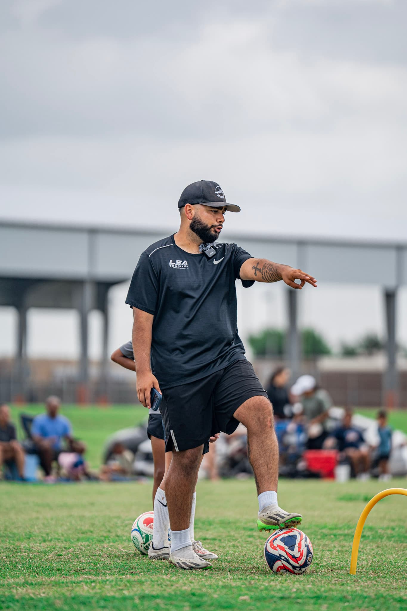 Coach Carlos Lara directing players during a session