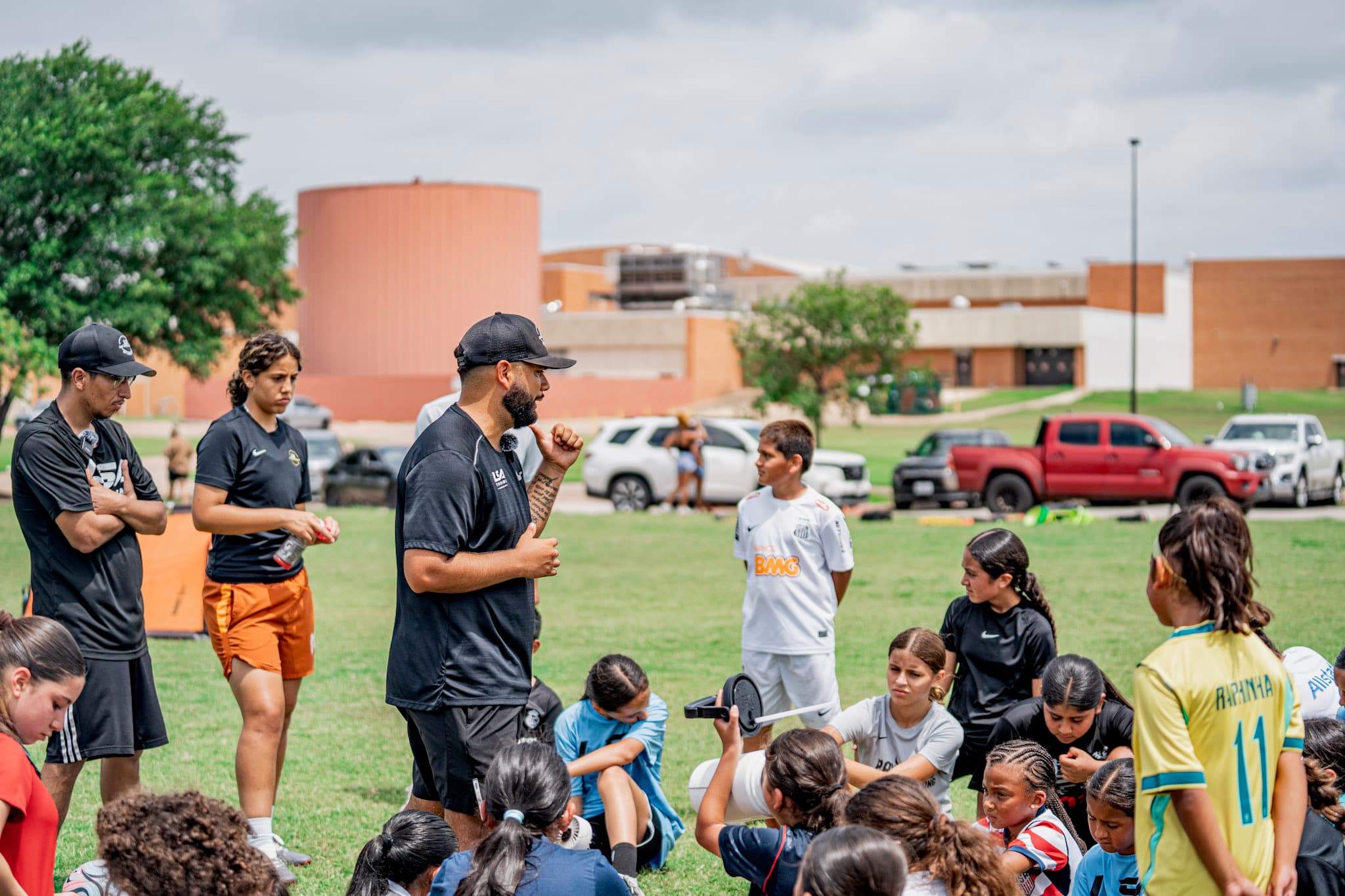 Coach Carlos Lara talking with a group of players